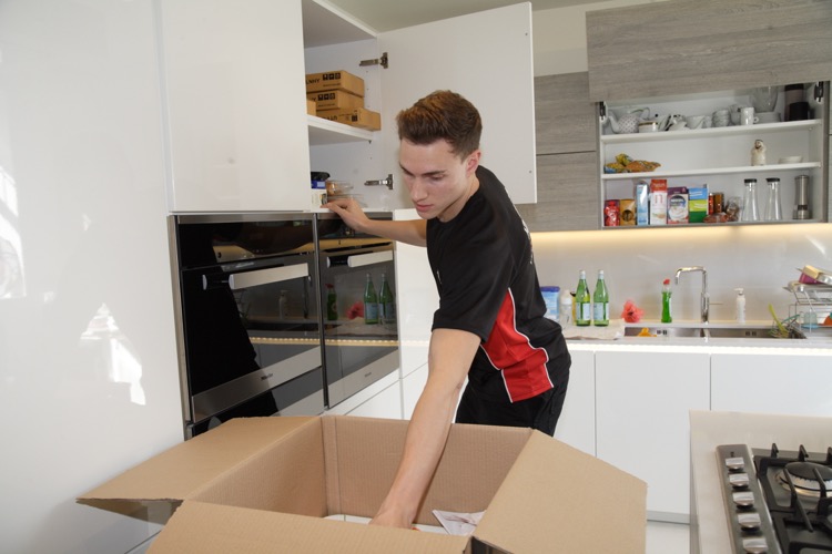 Removals man packing away a TV